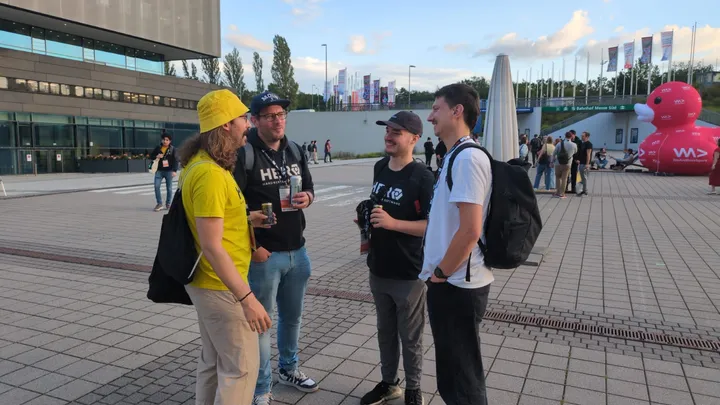 Group of four people standing and talking